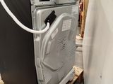 an image of a dishwasher sitting on a pallet in a warehouse