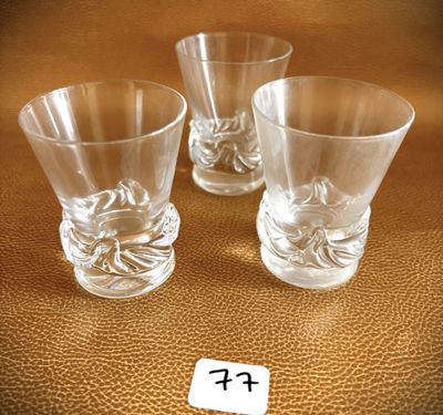 three shot glasses sitting next to each other on a table