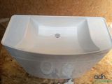 a white sink sitting on top of a wooden floor
