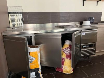 a kitchen with a stainless steel counter top and a microwave