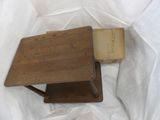 a small wooden table with a book on top of it