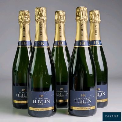four bottles of champagne are lined up in a row