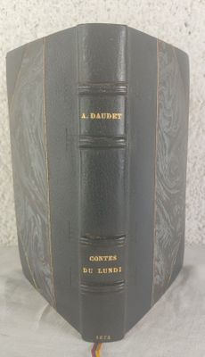 a book that is sitting on a table in front of a wall