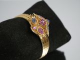 a close up of a ring on top of a black hat