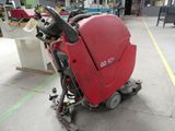 a red machine that is sitting on the floor