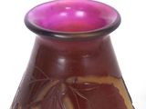 a purple vase with a leaf design on it