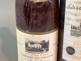 two bottles of wine sitting next to each other on a table