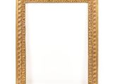 an old gold frame with a decorative pattern on a white background