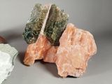 some rocks and crystals are sitting on a table next to each other