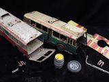 a small toy bus that is sitting on a black surface