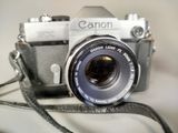 a camera that is sitting on a table with a strap around it