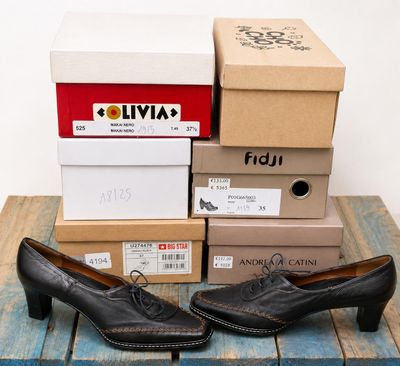 several boxes of shoes sitting on top of a wooden table