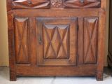 a wooden cabinet with a mirror on top of it