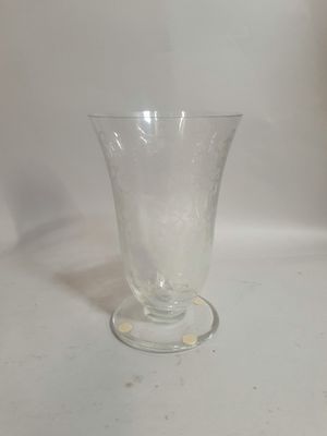 a clear glass vase sitting on a white surface