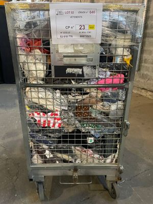 a metal cart with many items in it in a warehouse