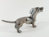 silver dog figurine on a white surface with a white background