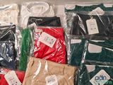 many different colored shirts in a plastic bag on a table