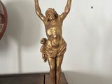 a gold statue of a woman on a wooden table