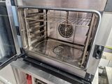 a silver oven with a fan inside of it in a kitchen