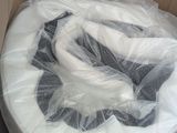 a cardboard box with a toilet in it that is wrapped in plastic