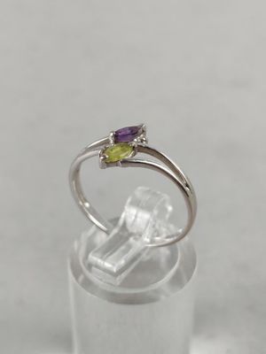 a close up of a silver ring with a purple and green stone