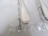 three spoons that are sitting on top of a plastic bag