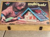 a wooden box with a picture of a child playing with a doll house