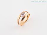 an image of a gold ring with a white diamond