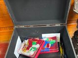a trunk with a bunch of items in it on the floor
