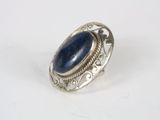 a close up of a silver ring with a blue stone in it