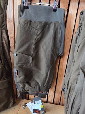 a pair of pants hanging on a rack in a room