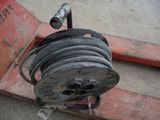 a hose attached to a metal reel on a pallet