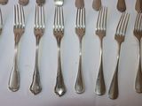 a lot of forks and spoons that are on the table
