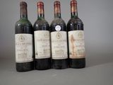 four bottles of wine are lined up on a table