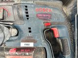 a box with a drill and other tools inside of it