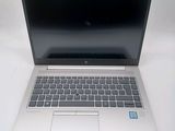 an open laptop computer sitting on top of a white table