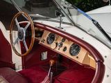 a dashboard and steering wheel of a vintage car
