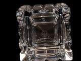 a clear glass candle holder with a clock on it