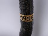 a close up of a black and gold cane with a name on it