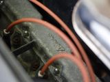 a close up of a car ' s engine with wires attached to it