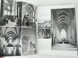 a person holding a book open to a picture of a church