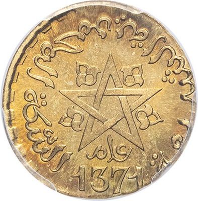 a close up of a gold coin with a star on it