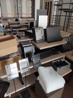 a lot of computer equipment that are on the floor