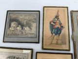 many framed pictures on the wall of a room