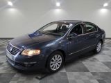 the blue volkswagen passat is parked on a checkered tile floor