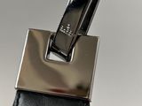 the handle of a black purse with a metal buckle