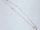 a close up of a rosary on a white surface
