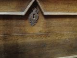a wooden chest with a lock on it in a room