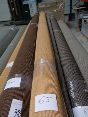 many rolls of brown fabric on the floor