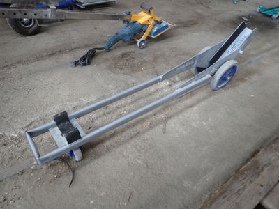 a dolly that is laying on the ground next to other items